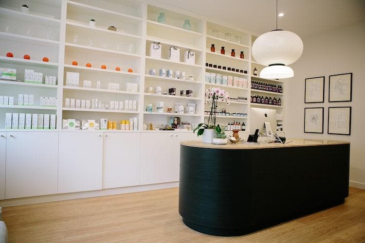 Serene facial treatment room with marble countertops, fresh flowers, crystals and potted plants at Vaia Beauty clinic in Darlinghurst