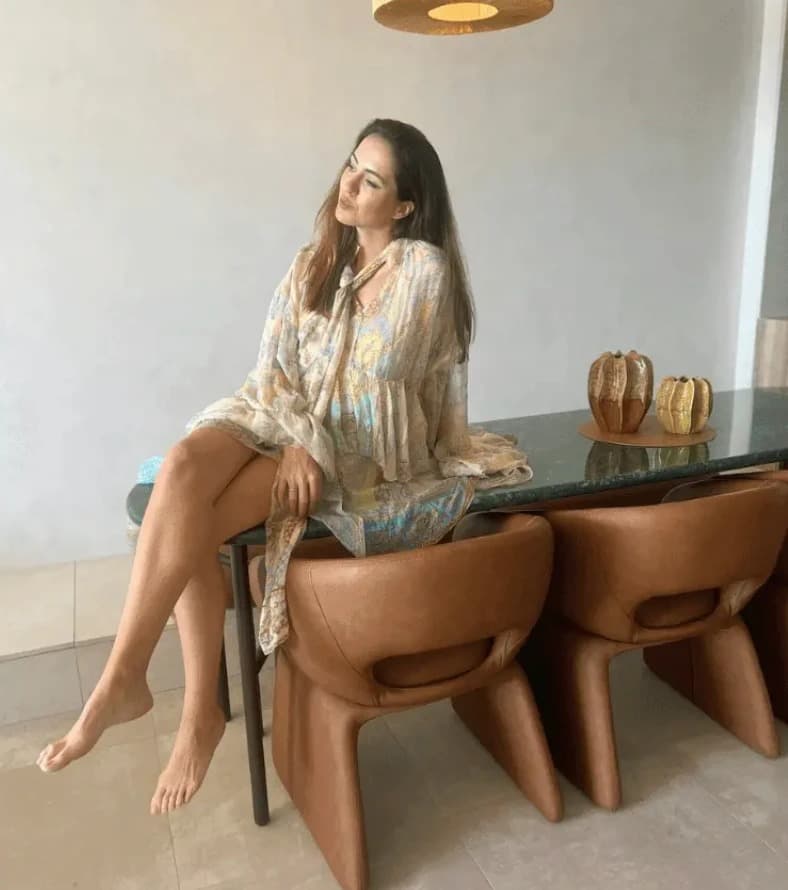 Sigourney Cantelo seated on a marble dining table at the Mondrian Gold Coast