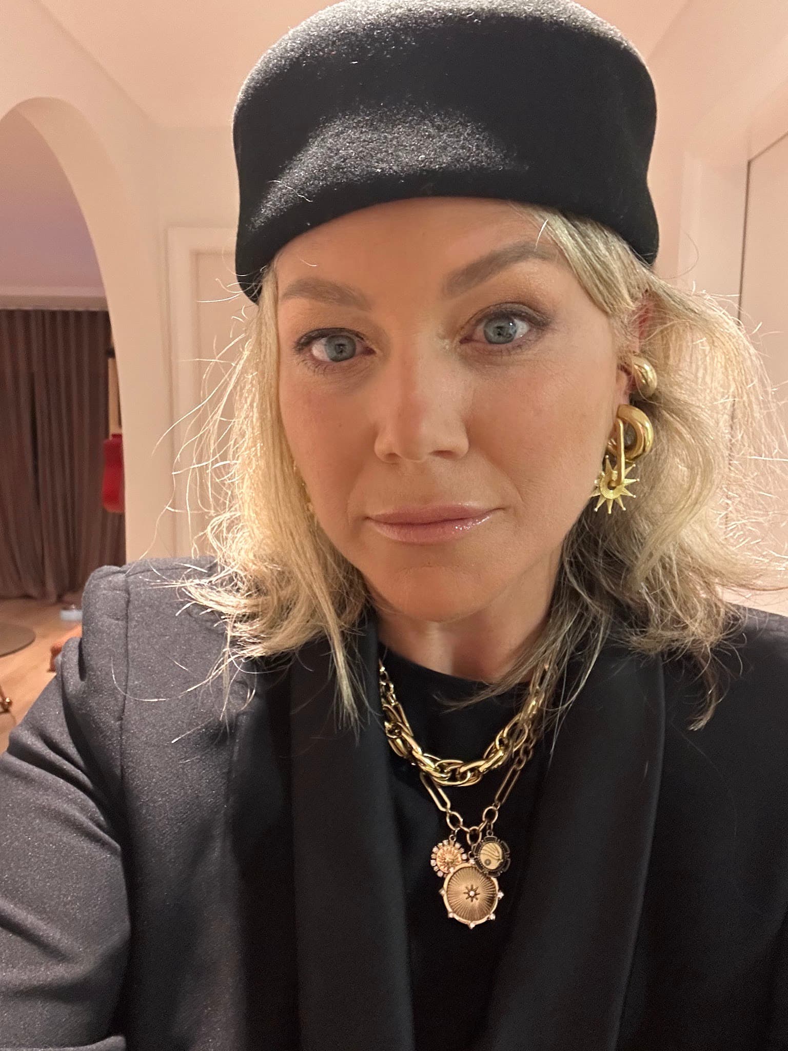 Colette Harvey wearing a black beret and gold jewellery