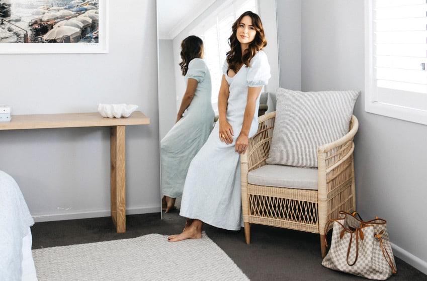 Beautifully styled coastal bedroom with white linen bedhead, Cultiver throws and rattan accents