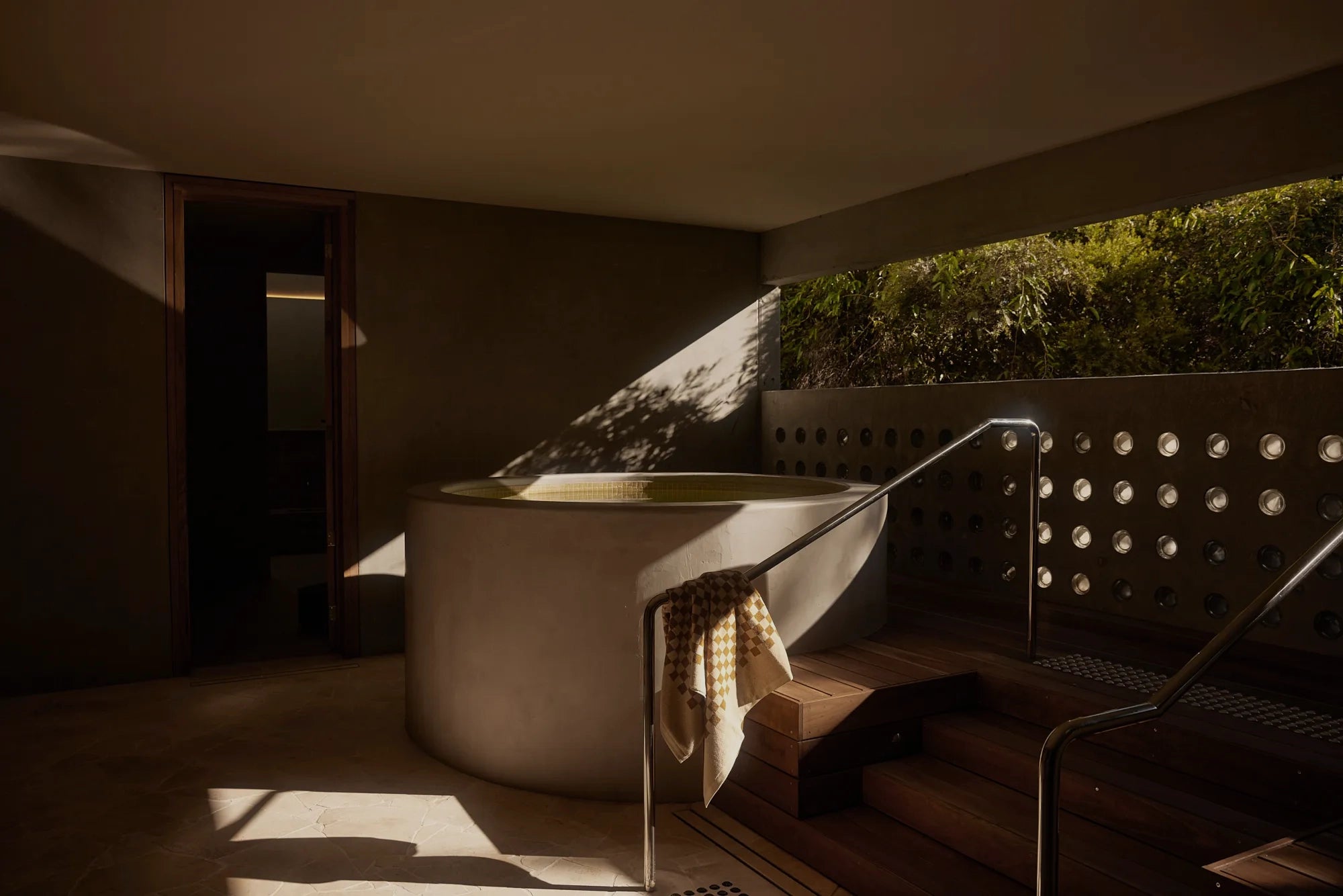 Comma, Cremorne, intimate bathhouse with custom Ross Gardam lighting