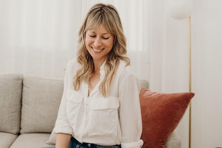 Almira Armstrong in her stylish Sydney home, wearing casual chic style with white tee and black blazer