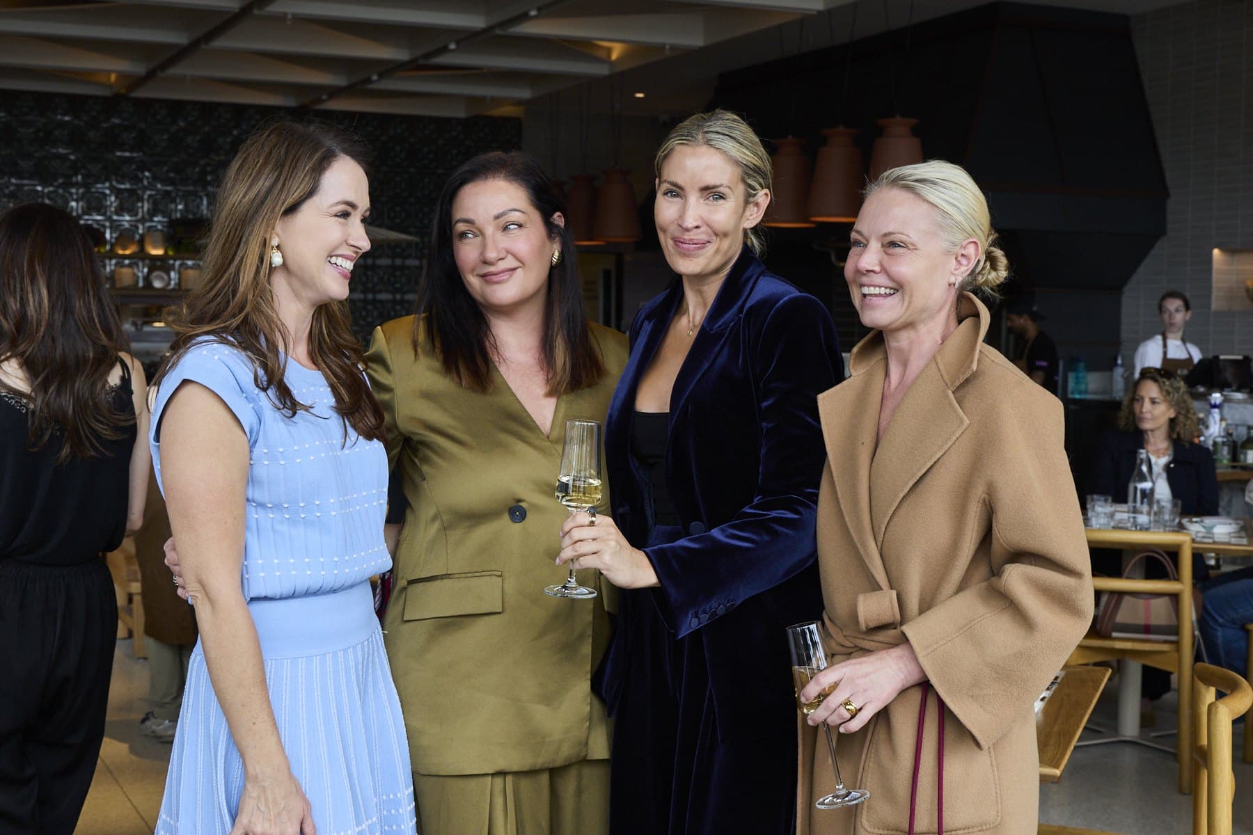 Four guests posing together at Lua, smiling at the camera