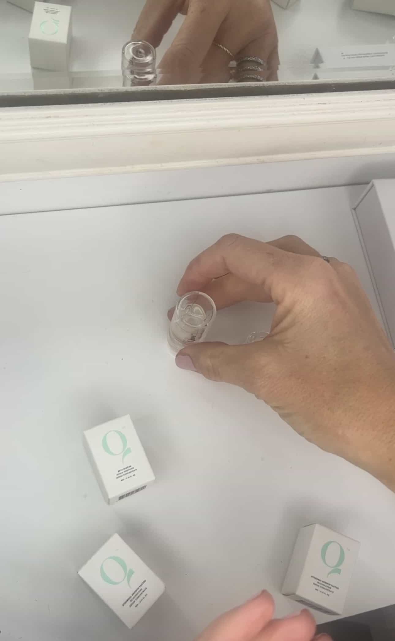 Qure micro-infusion single-use serum ampoules on a vanity.