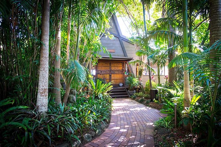 The paths are through rich green foliage to Kukura House