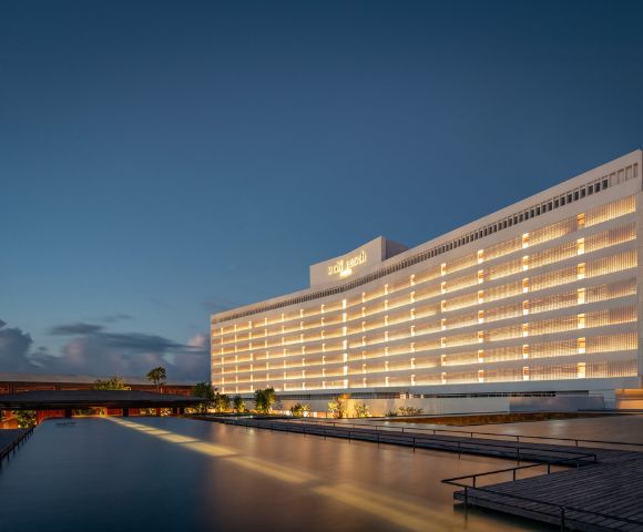 The exterior of Bali Beach Hotel, the grand dame and first high-rise hotel in Sanur, with its distinctive mid-century architecture set against tropical gardens