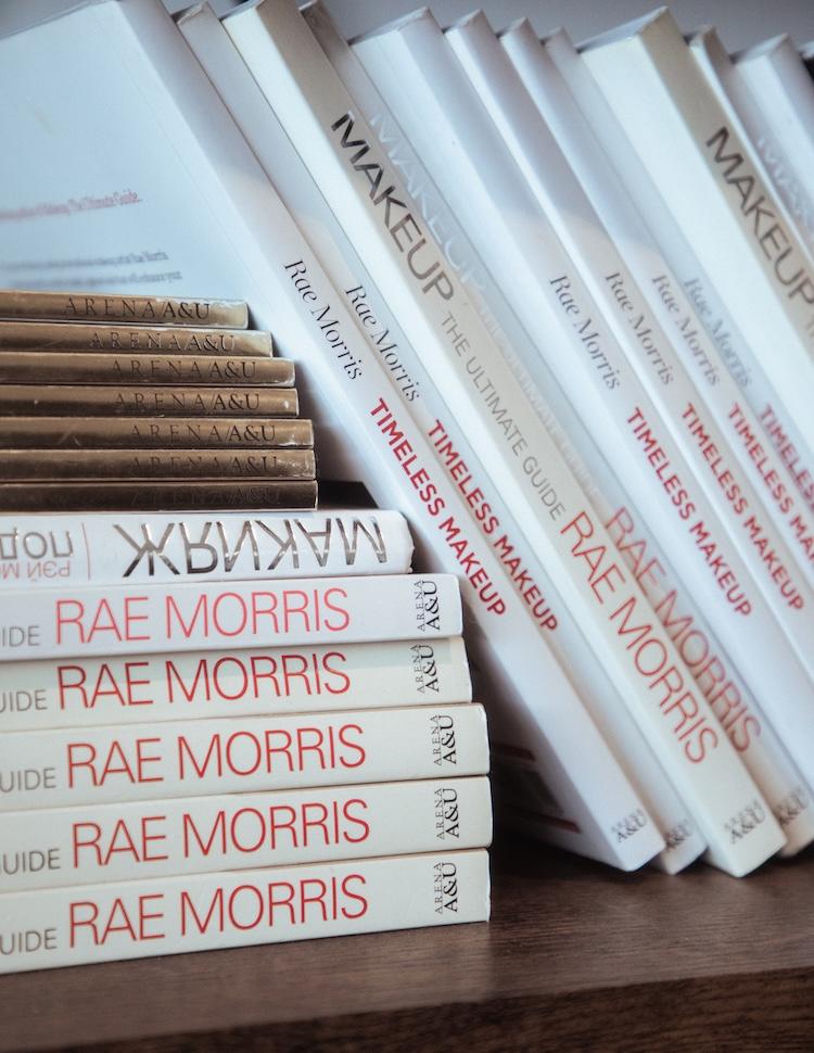 Stacked copies of Rae Morris Timeless Makeup and Makeup The Ultimate Guide books on a wooden shelf